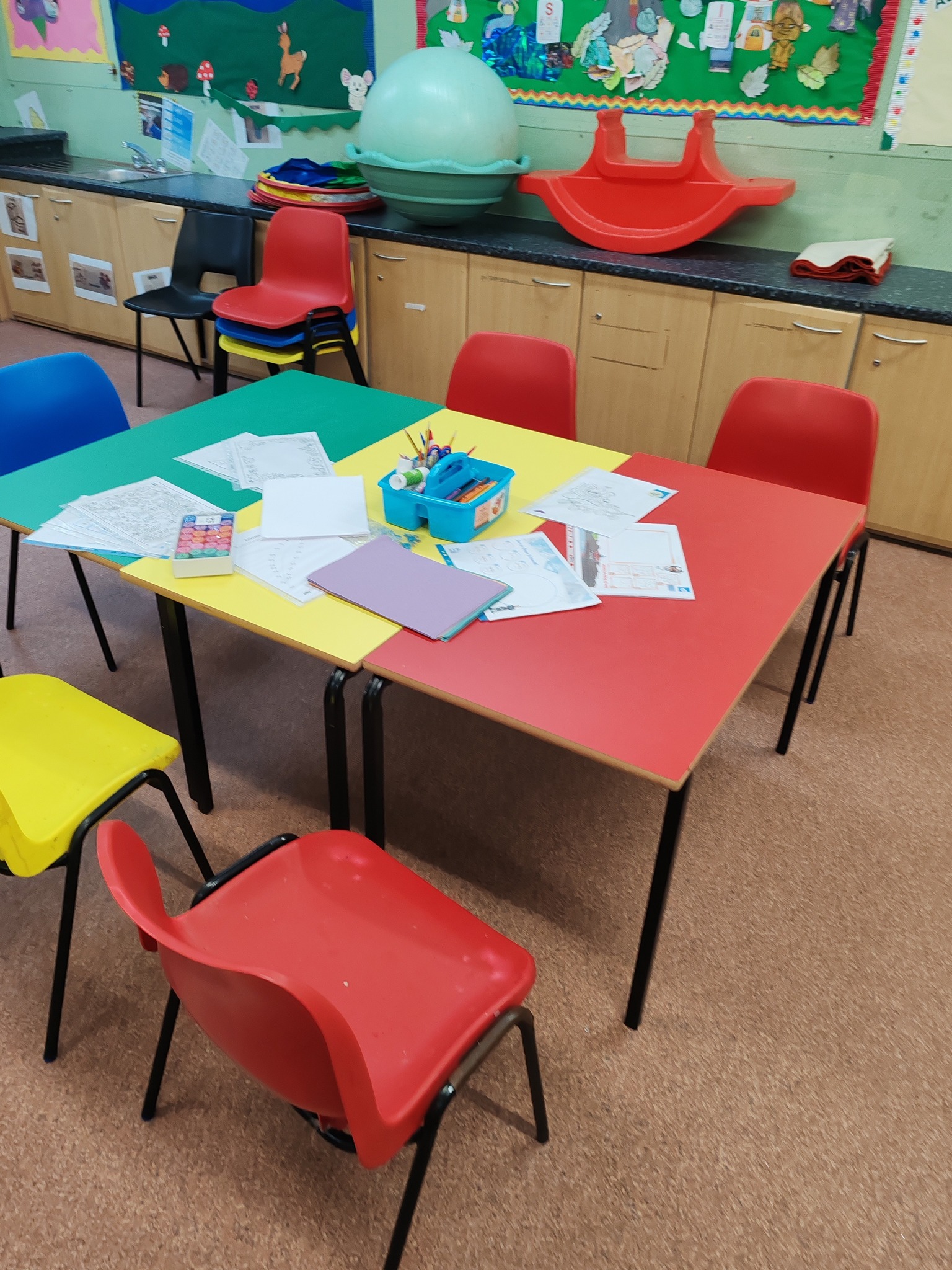 Colourful craft tables and chairs set up in the room