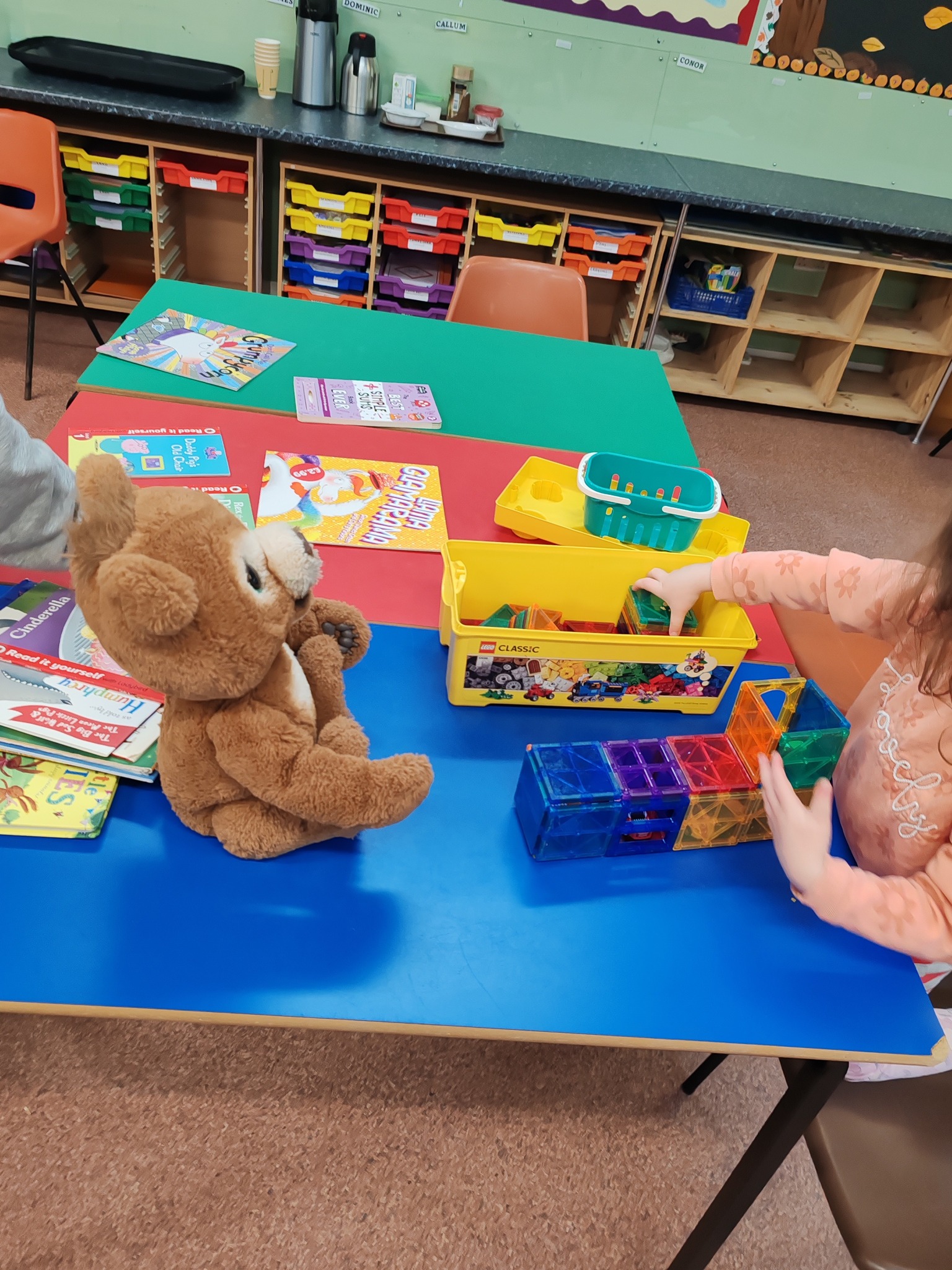 Activity table with books, blocks, and a soft toy